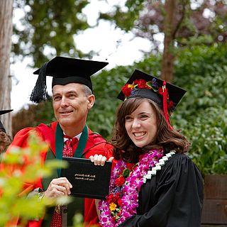 Photo of John 麦克维恩 and his daughter smiling at graduation